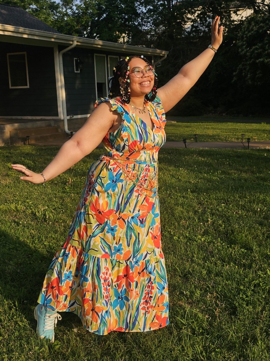 Alora twirling in a floral dress outdoors