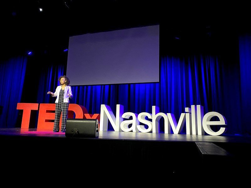Alora Young speaking on the TEDxNashville stage